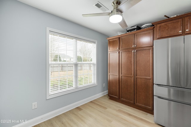 kitchen with stainless steel refrigerator, ceiling fan, and light wood-type flooring