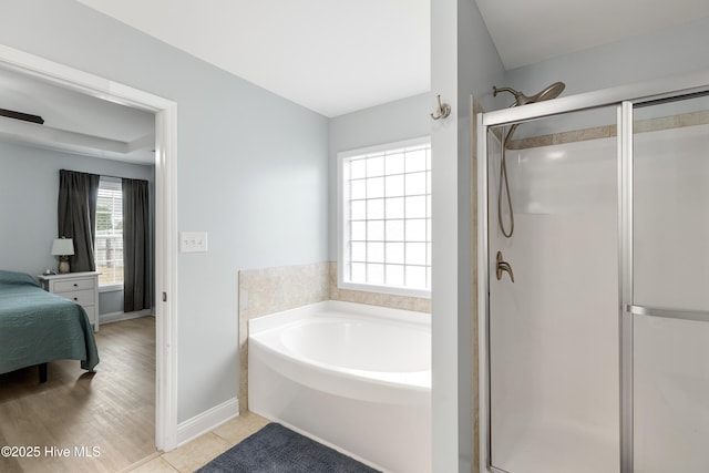 bathroom featuring tile patterned flooring and plus walk in shower