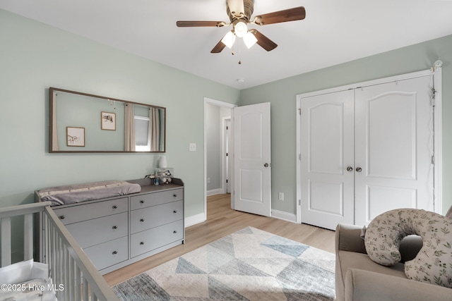 bedroom featuring ceiling fan, light hardwood / wood-style floors, and a closet