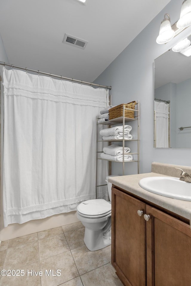 bathroom with tile patterned flooring, vanity, and toilet