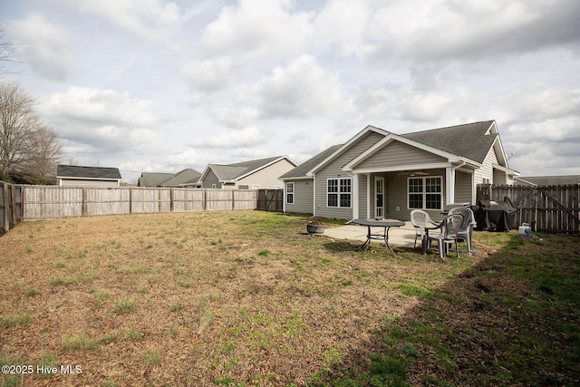 back of property featuring an outdoor fire pit, a yard, and a patio area