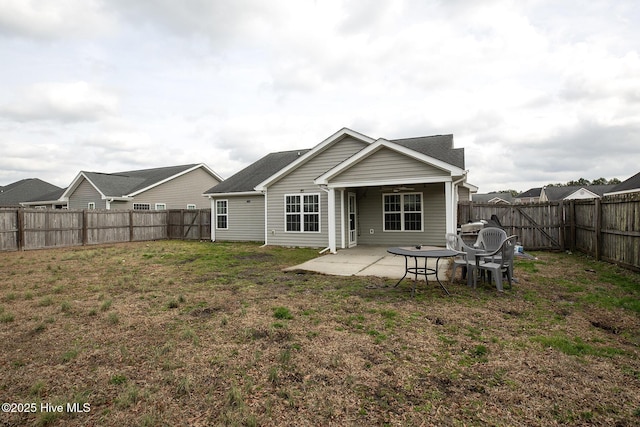 back of house with a yard, a patio, and ceiling fan