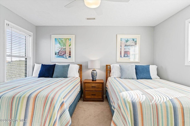 bedroom featuring light carpet and ceiling fan