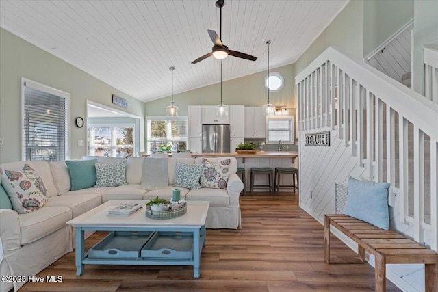 living room with dark wood-type flooring, ceiling fan, high vaulted ceiling, and wooden ceiling