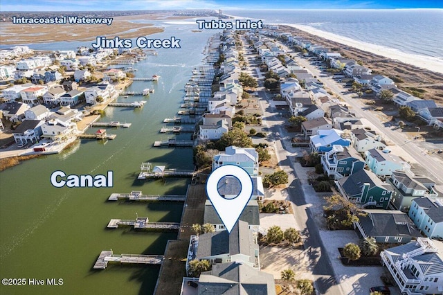 aerial view with a water view and a beach view