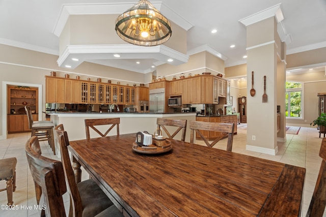 tiled dining area with crown molding and a chandelier