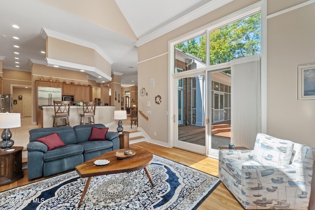 living room with crown molding, high vaulted ceiling, and light wood-type flooring