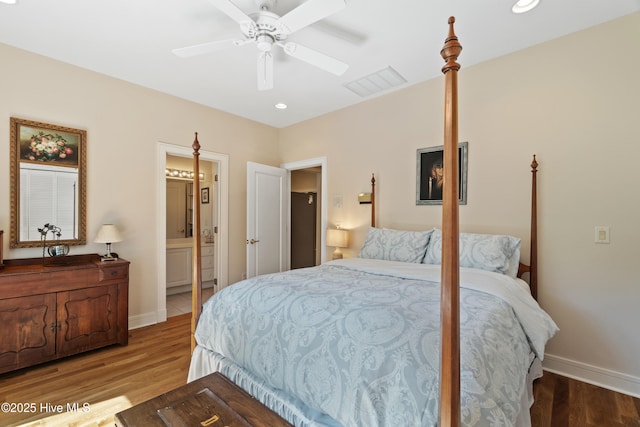 bedroom featuring ensuite bathroom, hardwood / wood-style floors, and ceiling fan