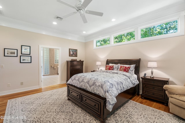 bedroom featuring crown molding, ceiling fan, and light hardwood / wood-style flooring