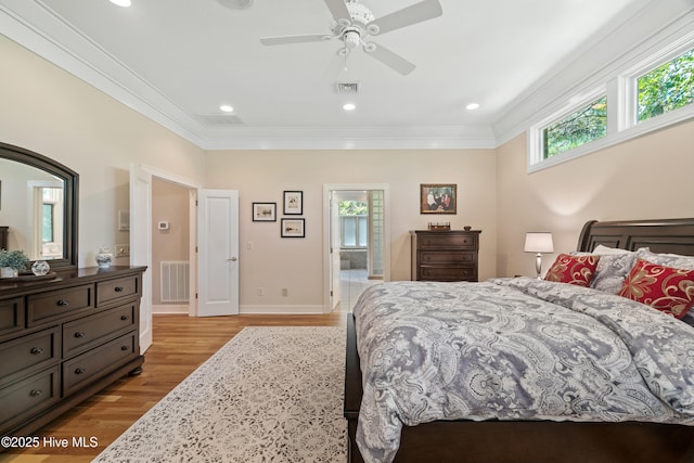 bedroom featuring crown molding, ceiling fan, and light wood-type flooring