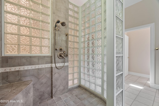 bathroom featuring tiled shower and tile patterned floors