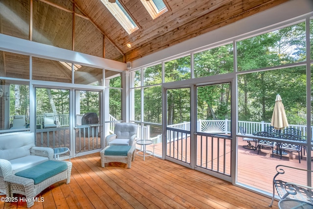 sunroom featuring wood ceiling and vaulted ceiling with skylight