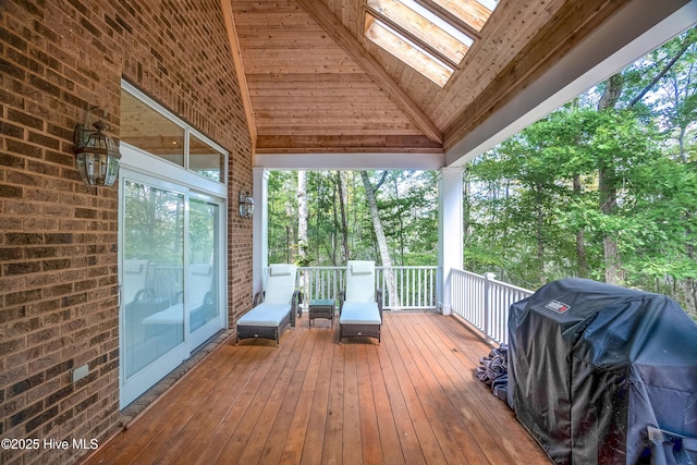 wooden terrace featuring a grill