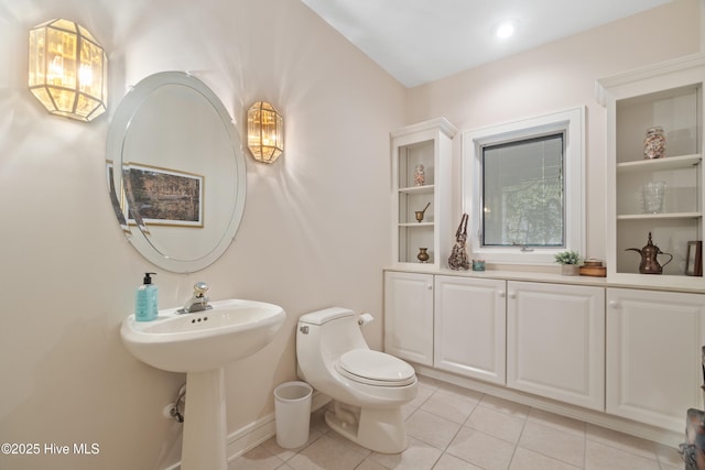 bathroom with tile patterned flooring and toilet