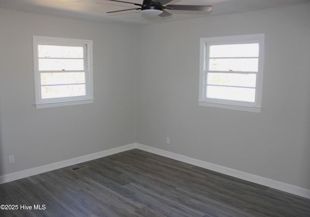 spare room with plenty of natural light, dark hardwood / wood-style floors, and ceiling fan