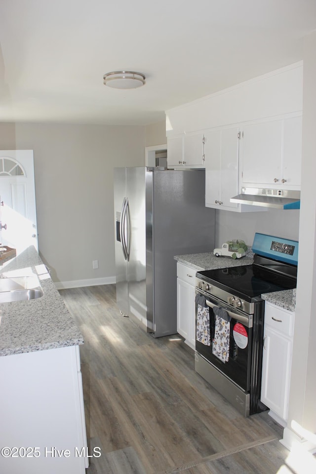 kitchen featuring white cabinetry, light stone counters, dark hardwood / wood-style flooring, and appliances with stainless steel finishes