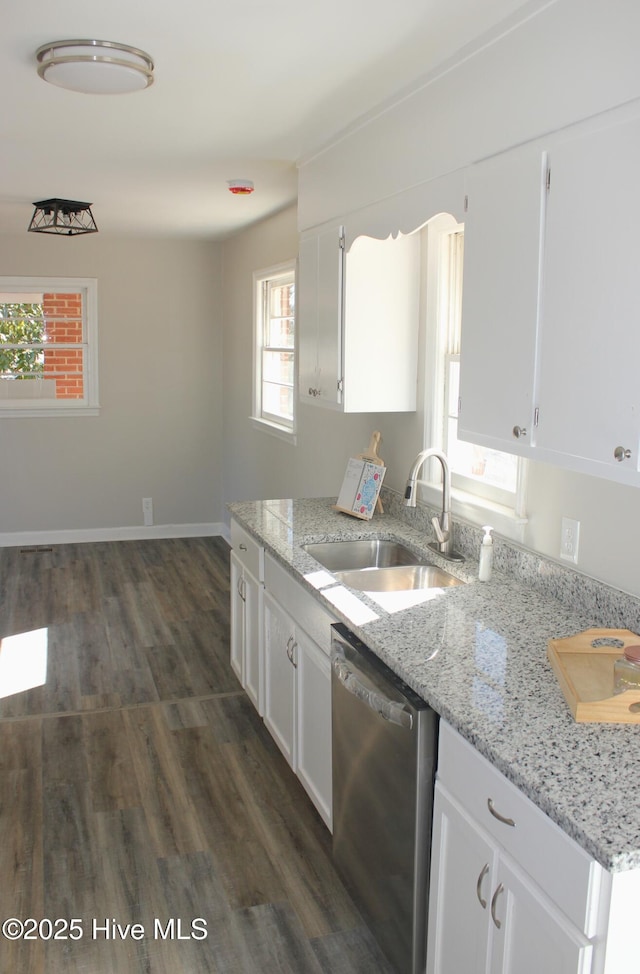 kitchen with white cabinetry, dishwasher, sink, and light stone counters