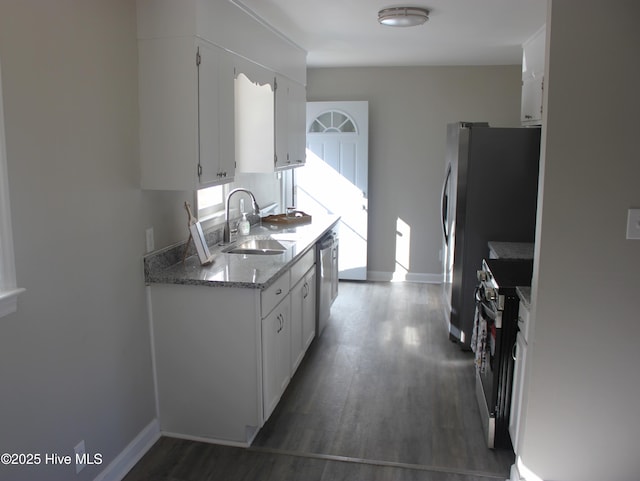 kitchen with stainless steel appliances, sink, dark wood-type flooring, and white cabinets