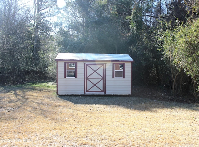 view of outbuilding featuring a yard