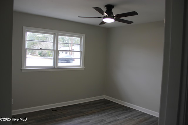 spare room featuring dark hardwood / wood-style floors and ceiling fan