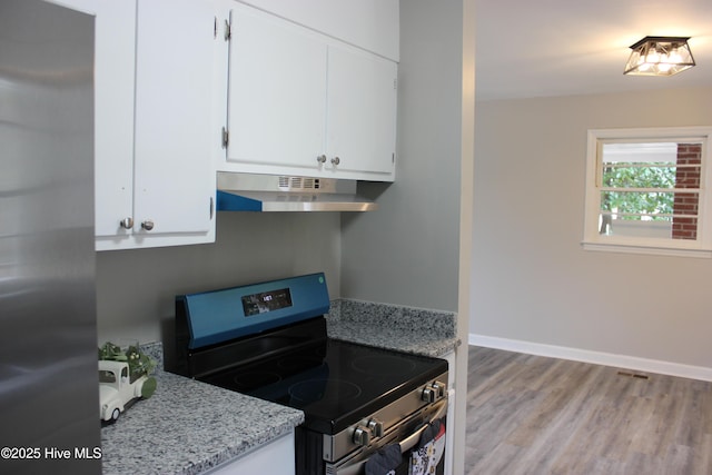 kitchen featuring white cabinetry, stainless steel appliances, light hardwood / wood-style floors, and light stone counters