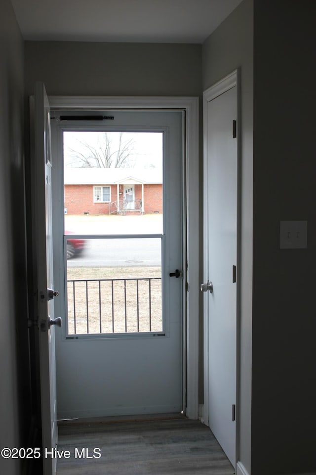 doorway with hardwood / wood-style floors