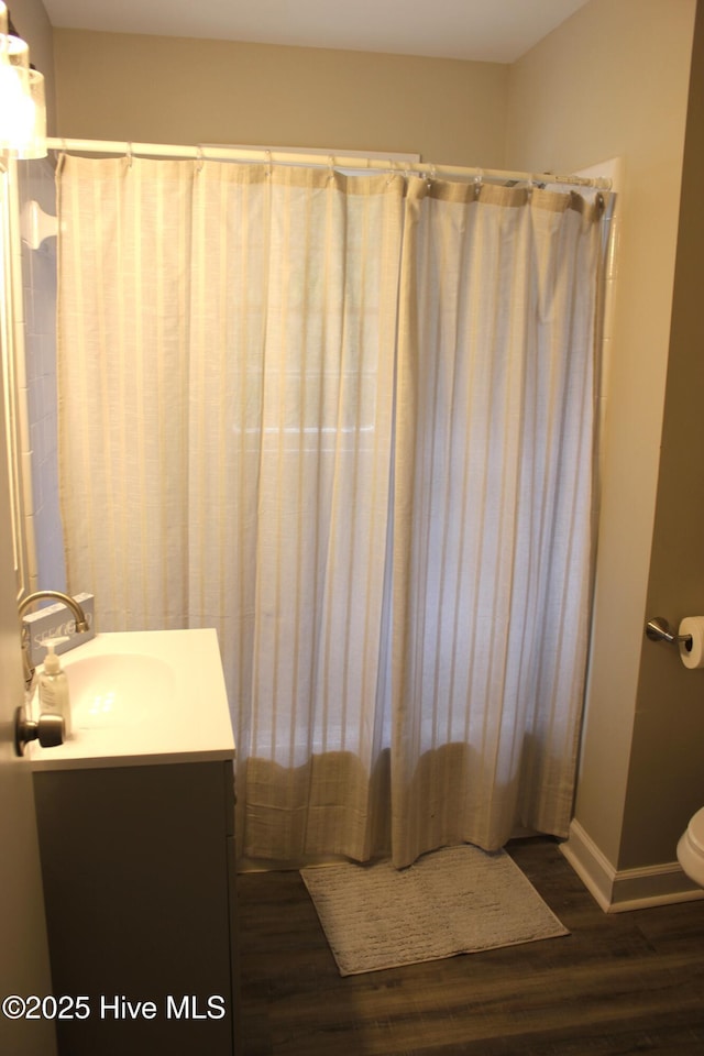 bathroom featuring hardwood / wood-style flooring, vanity, and toilet