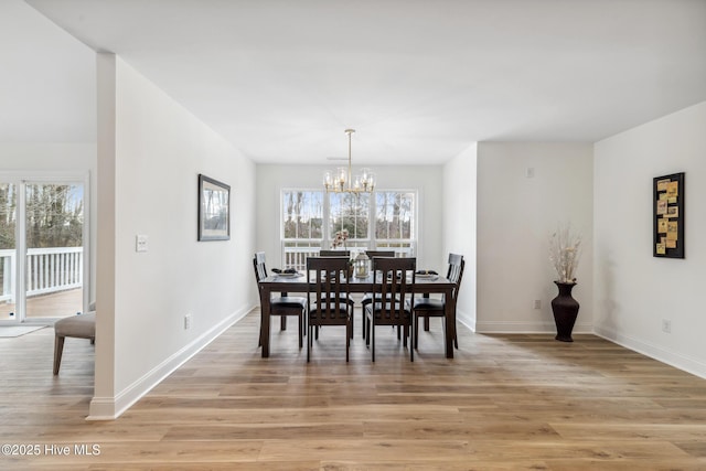 dining area with a chandelier and light wood-type flooring