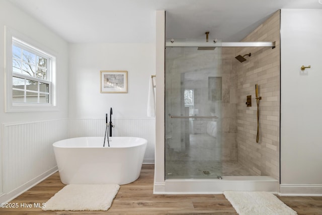 bathroom with plus walk in shower and hardwood / wood-style floors