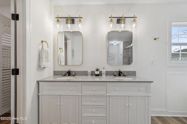 bathroom with hardwood / wood-style flooring, vanity, and an enclosed shower