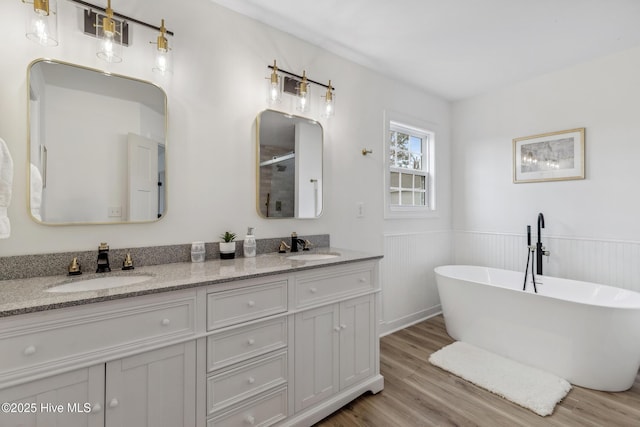 bathroom featuring vanity, separate shower and tub, and hardwood / wood-style floors