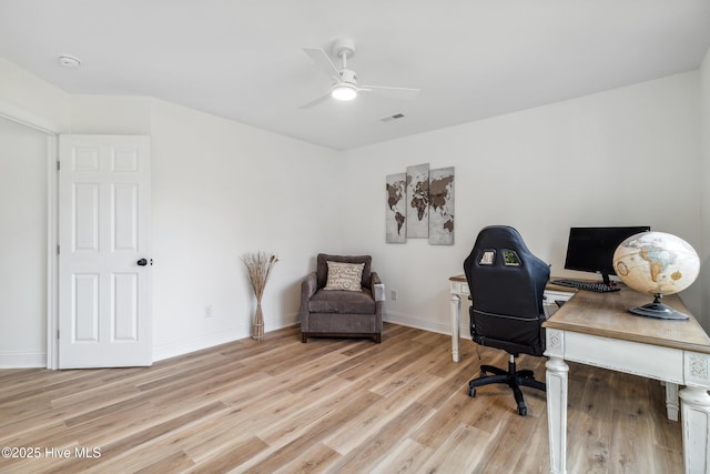 home office featuring ceiling fan and light hardwood / wood-style flooring