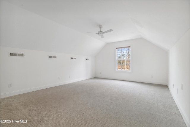 bonus room with lofted ceiling, light colored carpet, and ceiling fan