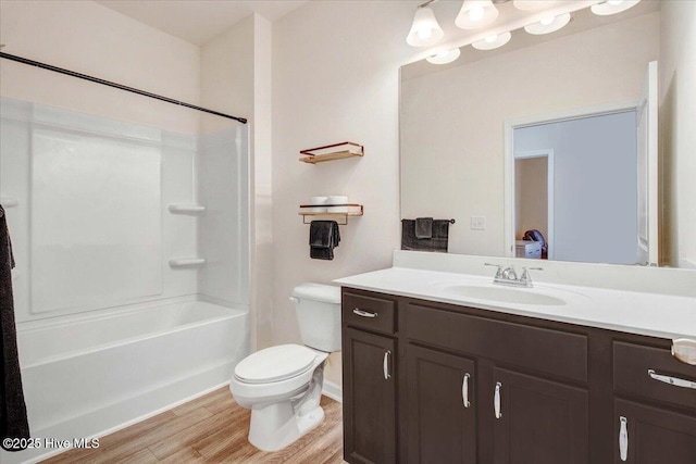 full bathroom with bathtub / shower combination, vanity, toilet, and hardwood / wood-style floors