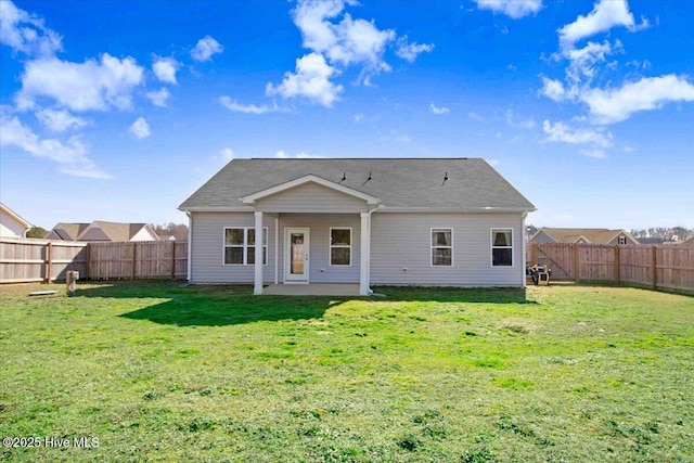 back of house featuring a lawn and a patio