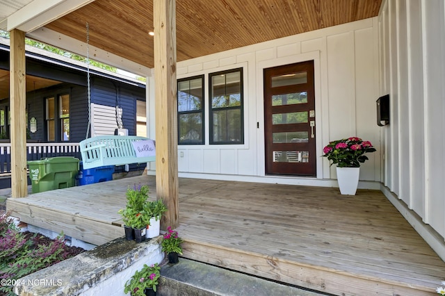 wooden terrace featuring covered porch