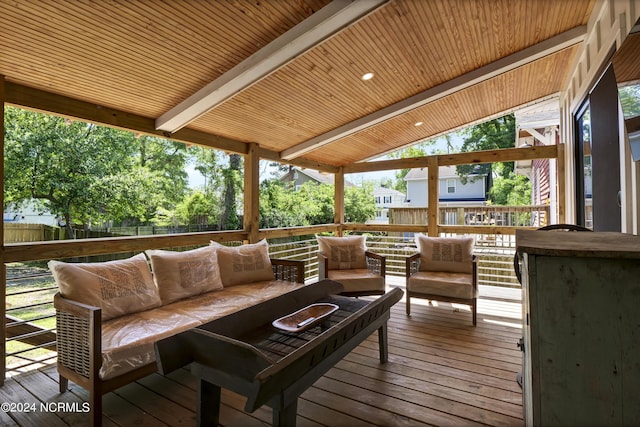 wooden terrace with an outdoor living space