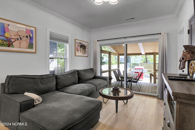 living room featuring crown molding, plenty of natural light, and light hardwood / wood-style floors