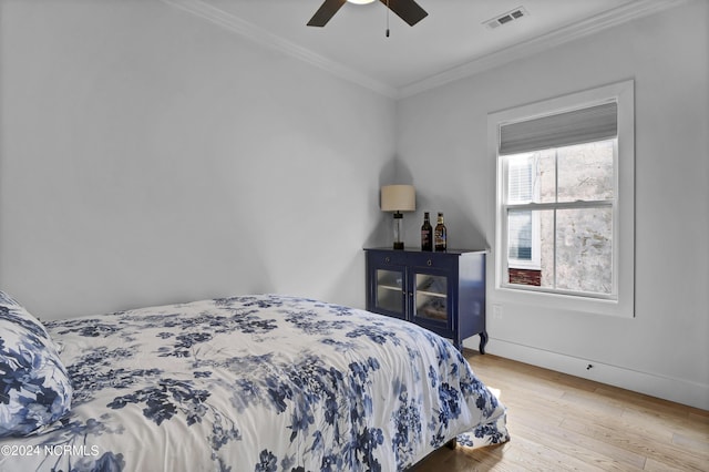 bedroom featuring crown molding, ceiling fan, and light wood-type flooring