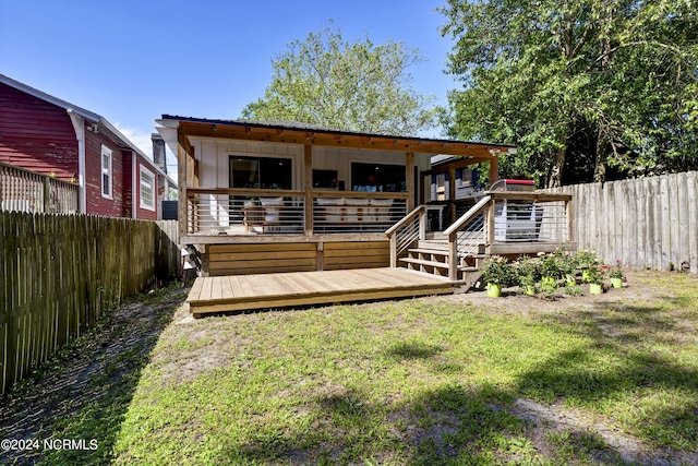 back of house with a yard and a deck