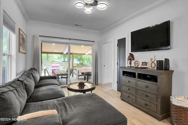 living room with ornamental molding and light wood-type flooring