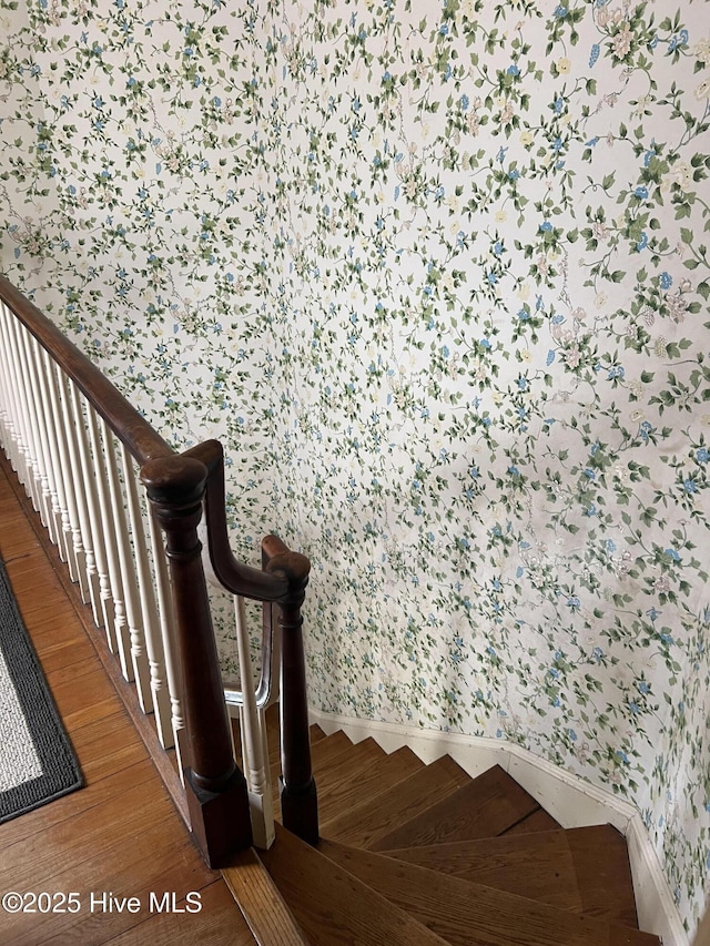 staircase with hardwood / wood-style flooring