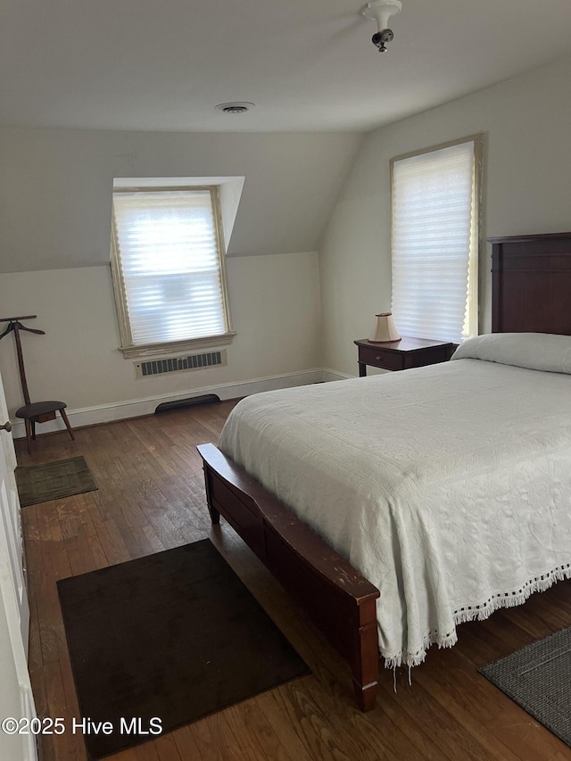 bedroom featuring lofted ceiling and dark wood-type flooring