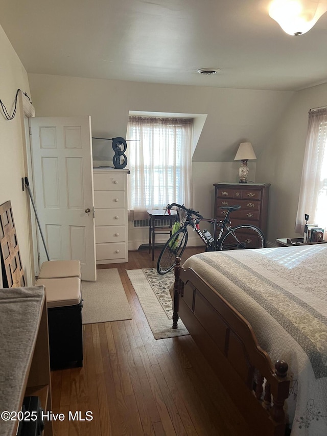 bedroom with dark hardwood / wood-style floors