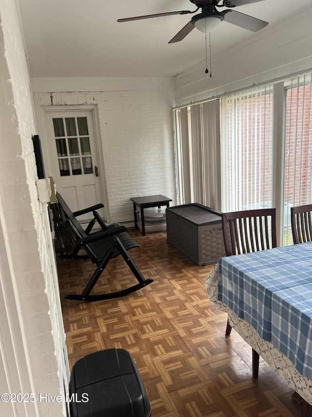 sunroom / solarium featuring ceiling fan