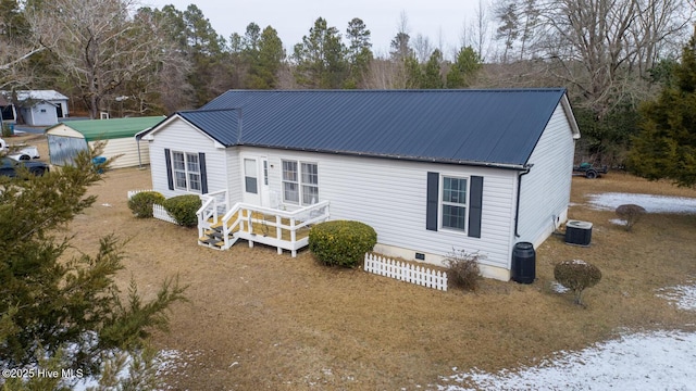 rear view of property with central AC