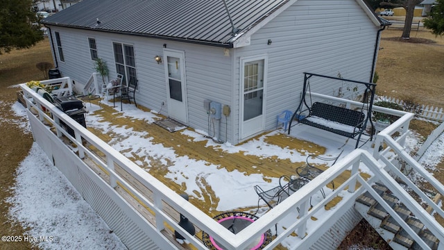 view of snow covered back of property