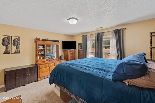 carpeted bedroom featuring a textured ceiling