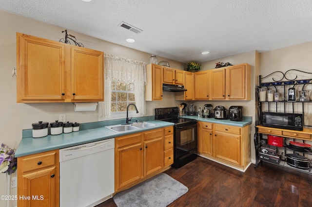 kitchen featuring sink, black appliances, dark hardwood / wood-style floors, and a textured ceiling