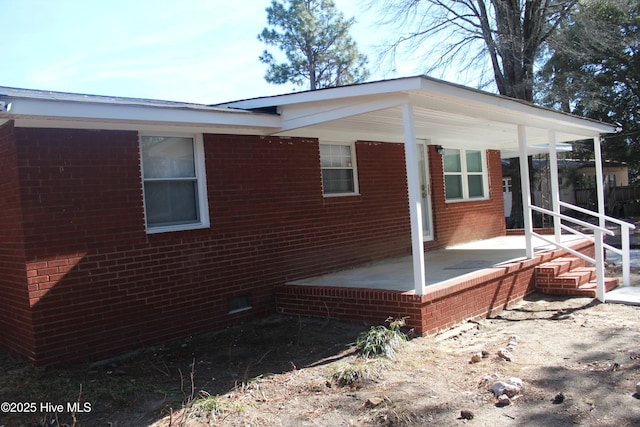 view of side of home with brick siding